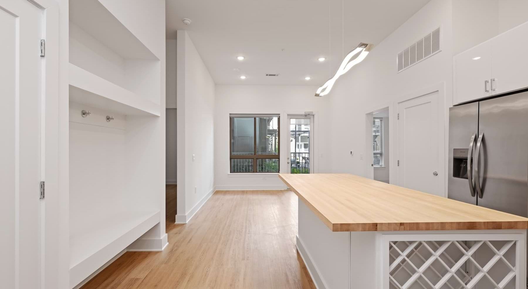kitchen with white cabinets, an island and wooden accents