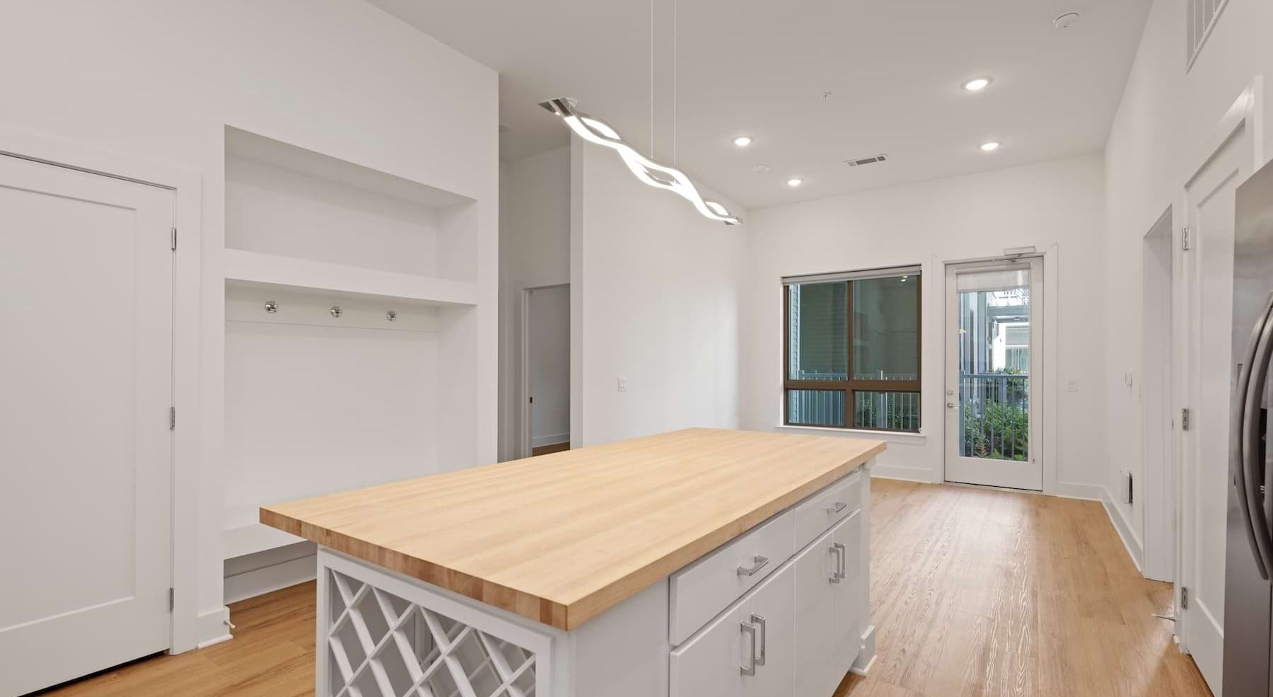 kitchen with white cabinets, an island and wooden accents
