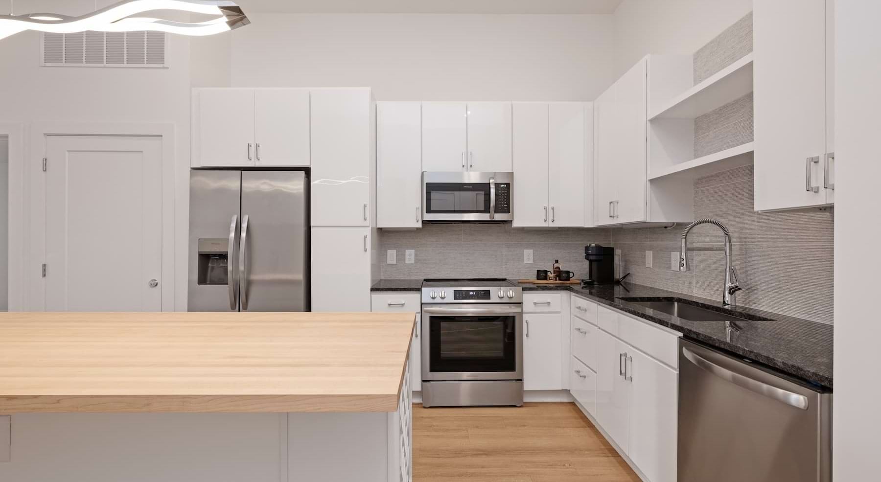 kitchen with white cabinets, an island and wooden accents