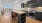 Spacious well lit kitchen with wood floors and stainless steel appliances