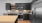Spacious well lit kitchen with wood floors and stainless steel appliances