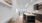 Spacious well lit kitchen with wood floors and stainless steel appliances