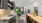 Spacious well lit kitchen with wood floors and stainless steel appliances