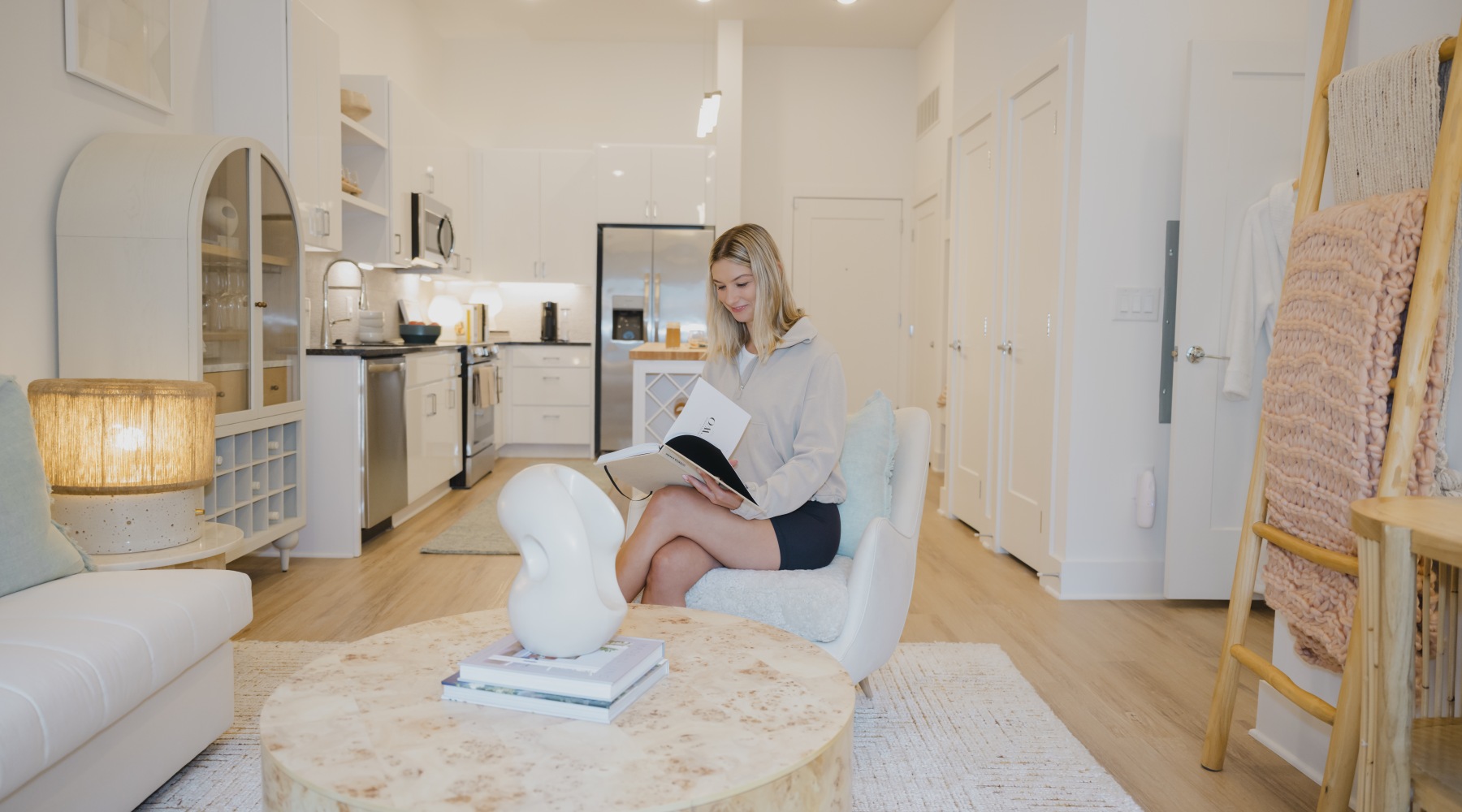 A person sitting in a furnished living area at Ello House apartments in Charlotte, NC A person sitting in a furnished living area at Ello House apartments in Charlotte, NC